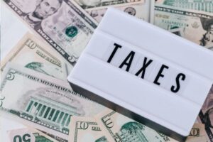 TAXES WRITTEN IN THE PAPER WITH DOLLAR MONEY